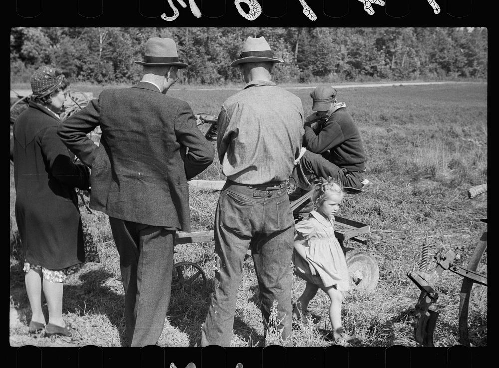 [Untitled photo, possibly related to: Farmers looking over sled at auction near Tenstrike, Minnesota]. Sourced from the…