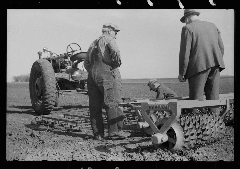[Untitled photo, possibly related to: County agent and farmer examining amount of gas in tank, Grundy County, Iowa]. Sourced…