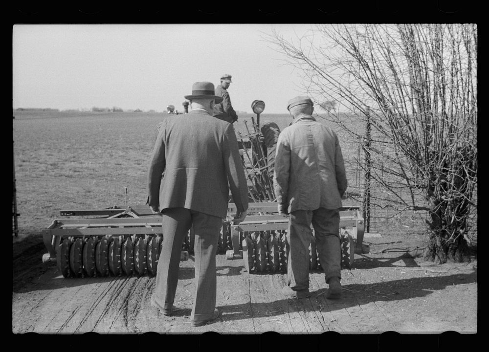 [Untitled photo, possibly related to: County agent and farmer examining amount of gas in tank, Grundy County, Iowa]. Sourced…