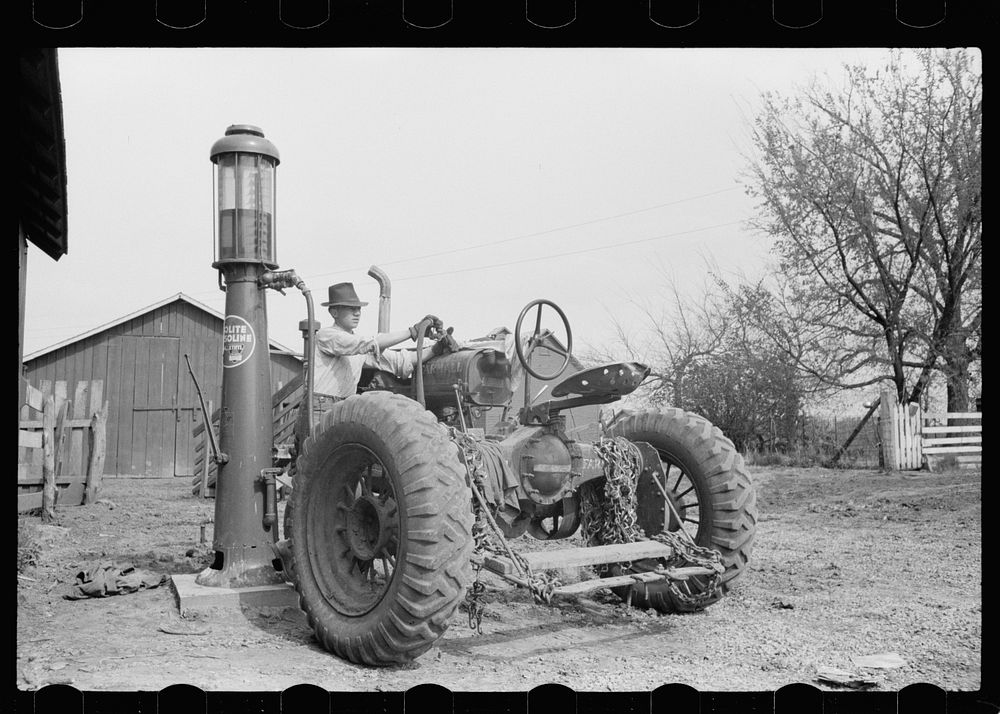 Gassing tractor on farm, Jasper County, Iowa. Sourced from the Library of Congress.