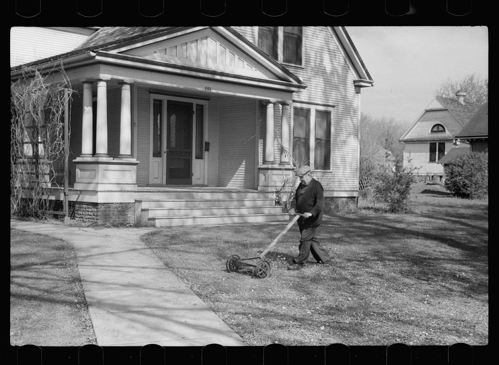 Man mowing lawn, Grundy Center, Iowa. Sourced from the Library of Congress.