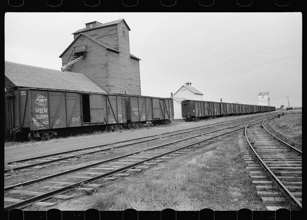 Grain elevators along railroad tracks, Free Photo rawpixel