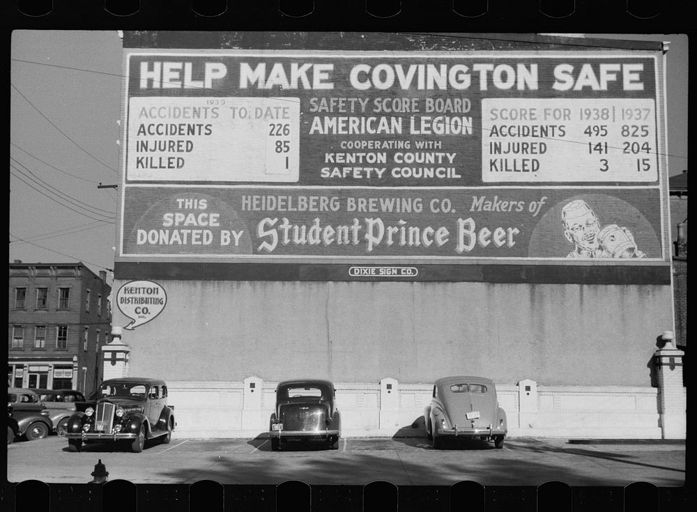 Parking lot, Covington, Kentucky. Sign on building: Help make Covington safe. Sourced from the Library of Congress.
