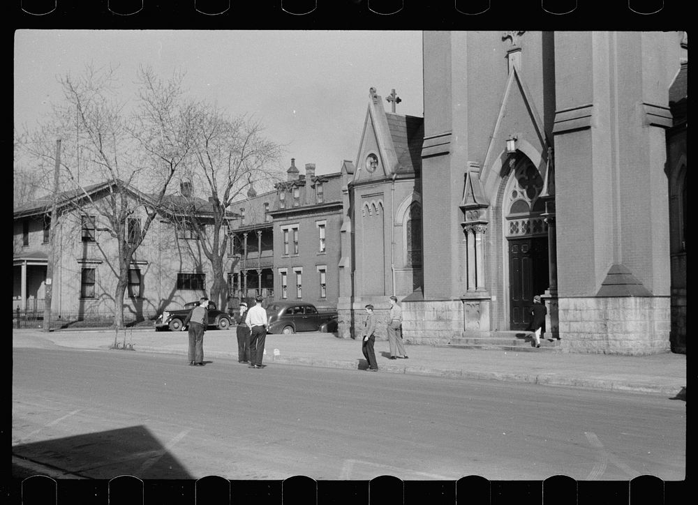 Parochial school children playing in front of church, before the school bell, Dubuque, Iowa. Sourced from the Library of…