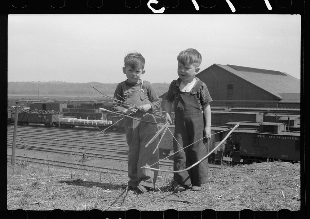 [Untitled photo, possibly related to: Boys playing with bows and arrows near railroad yards, Dubuque, Iowa]. Sourced from…