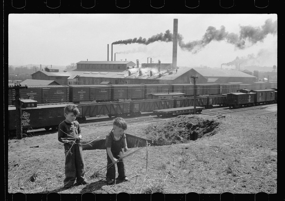 Boys playing with bows and arrows near railroad yards, Dubuque, Iowa. Sourced from the Library of Congress.