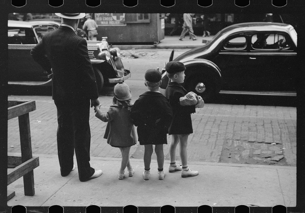 Father and three children waiting to cross the street, Chicago, Illinois. Sourced from the Library of Congress.