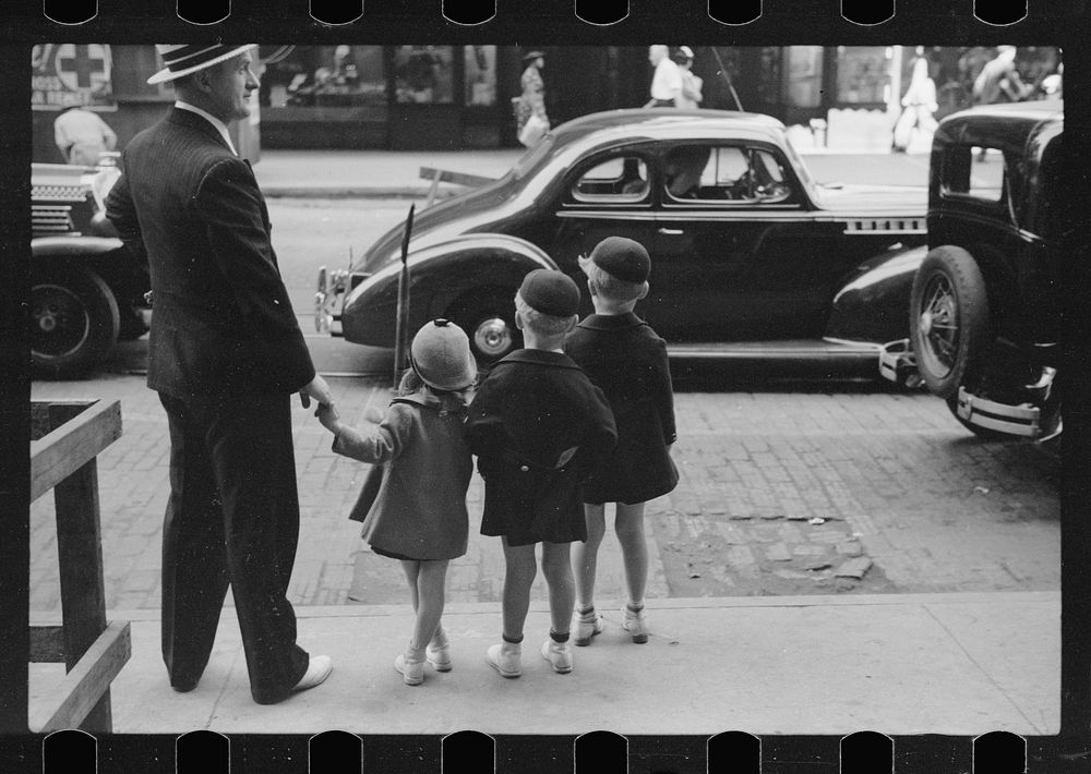 [Untitled photo, possibly related to: Father and three children waiting to cross the street, Chicago, Illinois]. Sourced…