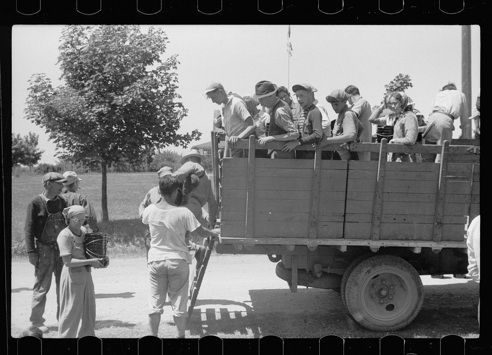 Cherry pickers getting off truck which brought them back to camp, Sturgeon Bay, Wisconsin. Sourced from the Library of…
