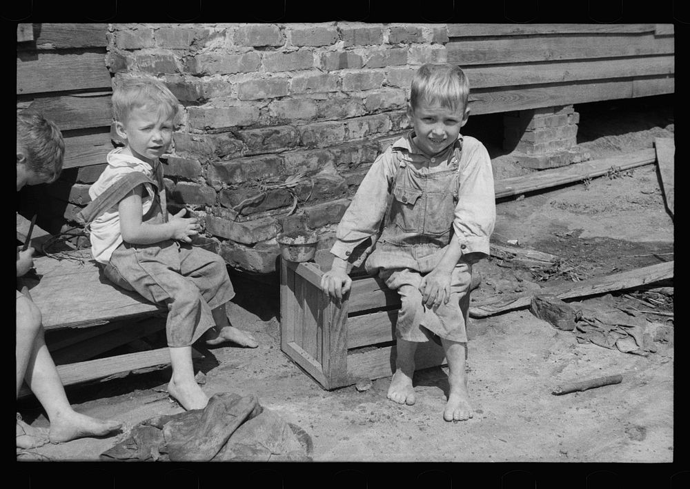 [Untitled photo, possibly related to: Son of a farmer on Wolf Creek Farms project who has not yet been moved to a new house…