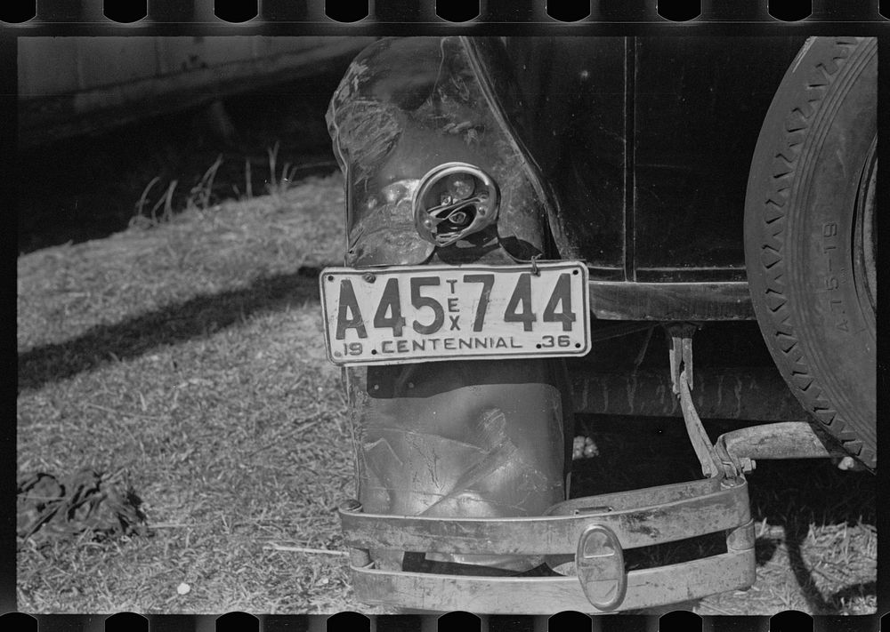 The battered rear of a migrant citrus worker's car. Winter Haven, Florida. Sourced from the Library of Congress.