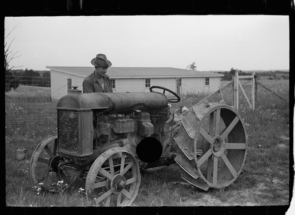 [Untitled photo, possibly related to: Farmer on Loogootee unit oiling tractor, Wabash Farms, Indiana]. Sourced from the…