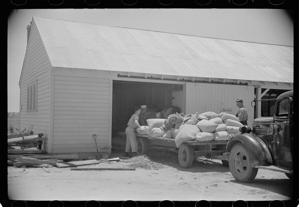 Loading supplies into shed, Wabash Farms, Indiana. Sourced from the Library of Congress.