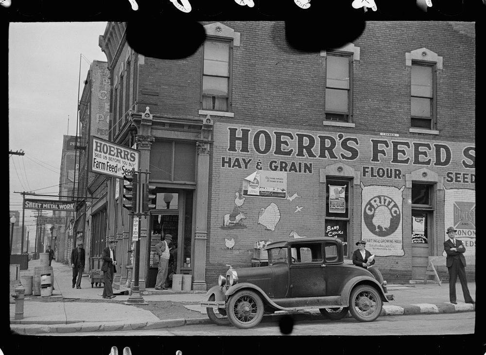 [Untitled photo, possibly related to: Waiting for a bus in front of feed store, Peoria, Illinois]. Sourced from the Library…