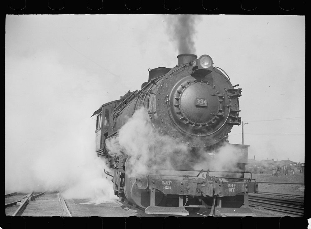 [Untitled photo, possibly related to: Locomotive in railroad yards along river, St. Louis, Missouri]. Sourced from the…