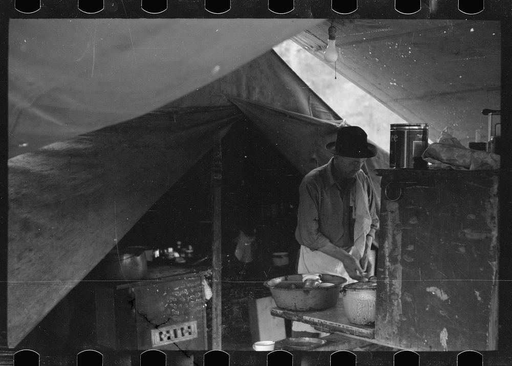 [Untitled photo, possibly related to: Cowboy eating in Three Circle roundup camp, Powder River County, Montana]. Sourced…