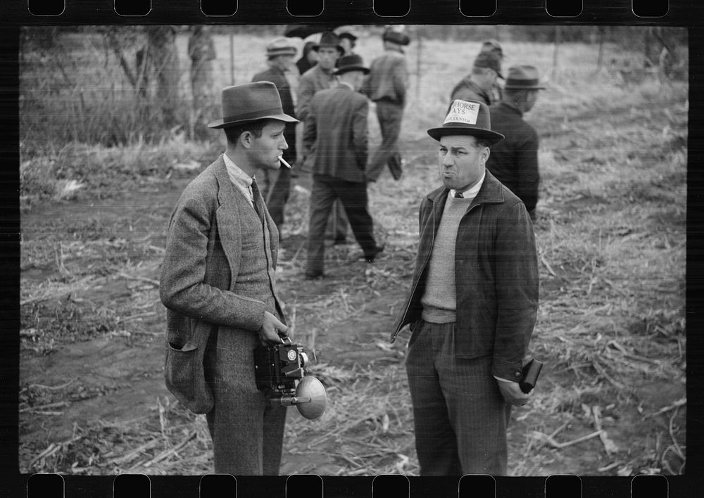 Photographer and editor of local paper at cornhusking contest, Marshall County, Iowa. Sourced from the Library of Congress.