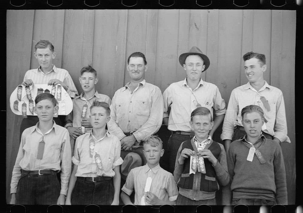 4-H Club boys, all sons of resettlement families on Western Slope Farms, Colorado, pose with their leader (top row, third…