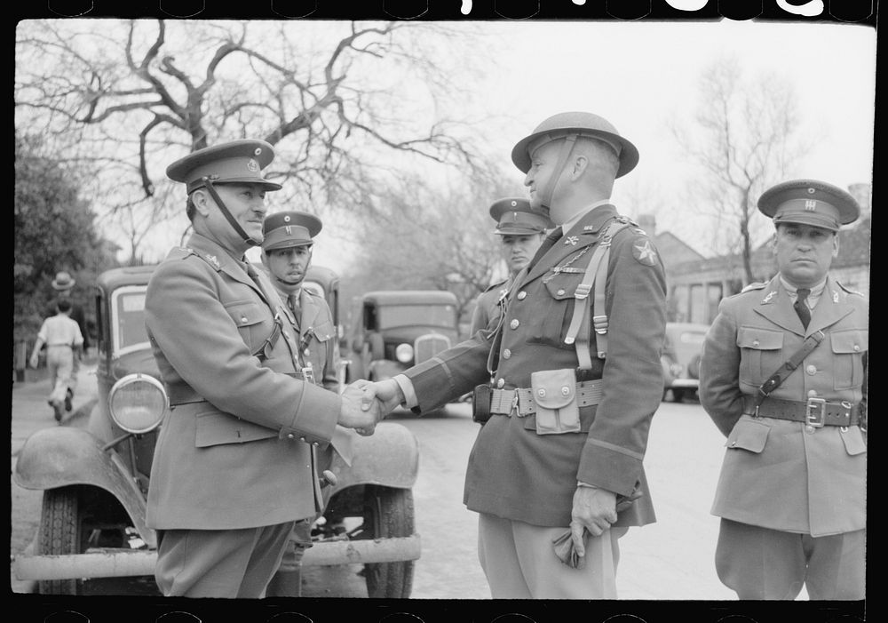 Mexican general and American colonel shake hands after review of troops in Charro Days parade, Brownsville, Texas. Sourced…