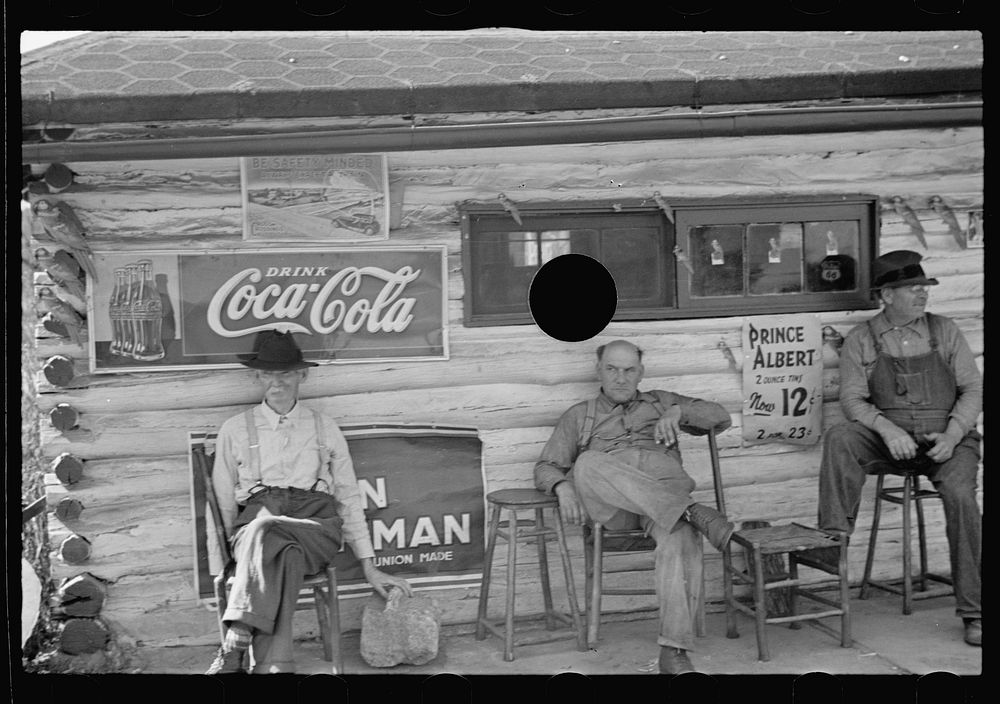 [Untitled photo, possibly related to: Noon-day siesta in front of a lunchroom at Helmsburg, Indiana]. Sourced from the…