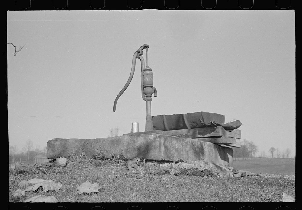 Pump, oilcan cut in half used as trough, Nashville, Brown County, Indiana. Sourced from the Library of Congress.