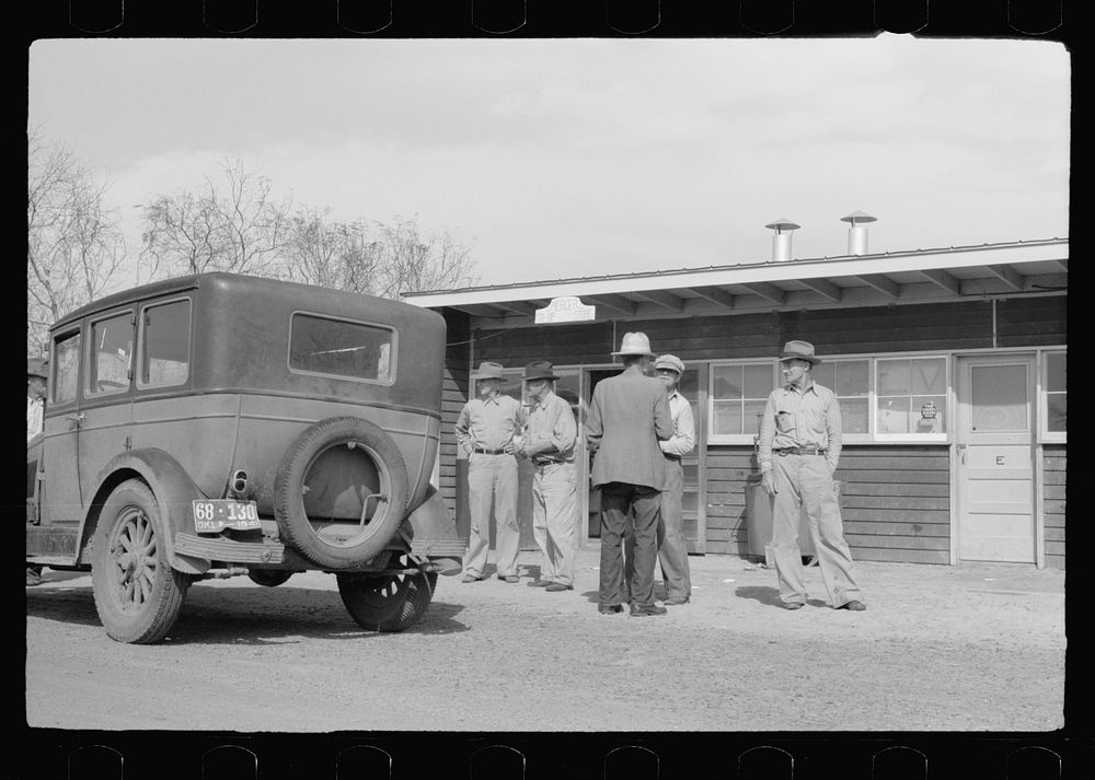 [Untitled photo, possibly related to: Migratory worker at coop store gas station, FSA (Farm Security Administration) camp…