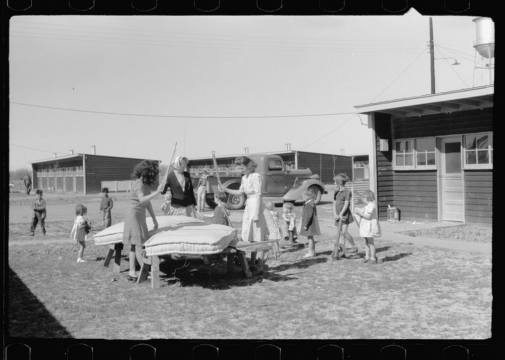 In front of the community store, FSA (Farm Security Administration) camp, Sinton, Texas. Sourced from the Library of…