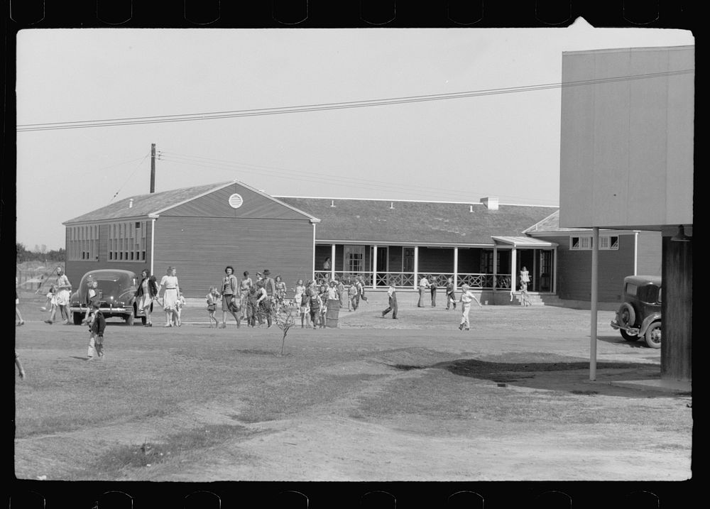 Noonday recess, elementary school, FSA (Farm Security Administration) camp, Weslaco, Texas. Sourced from the Library of…