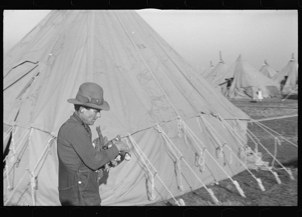 Man at work in the camp for white flood refugees, Forrest City, Arkansas. Sourced from the Library of Congress.