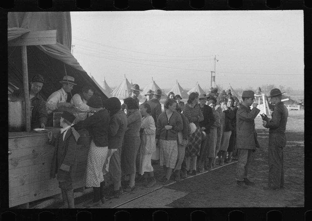 [Untitled photo, possibly related to: Line of flood refugees at mealtime in camp for white flood refugees at Forrest City…
