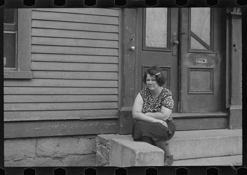 [Untitled photo, possibly related to: Woman sitting on step, Manchester, New Hampshire]. Sourced from the Library of…