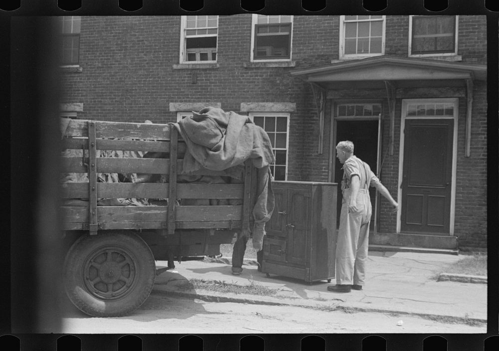 [Untitled photo, possibly related to: Loading a bureau into truck, Manchester, New Hampshire]. Sourced from the Library of…
