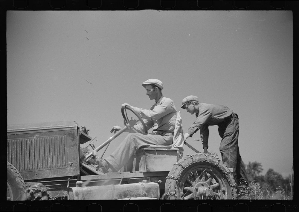 [Untitled photo, possibly related to: Luke Weldon, small farmer, and his son using ancient Buick (transformed by cutting…