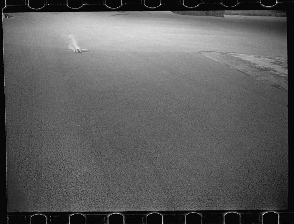 [Untitled photo, possibly related to: Dusting plane hedge-hopping after spraying swath on beanfield. These planes can spray…