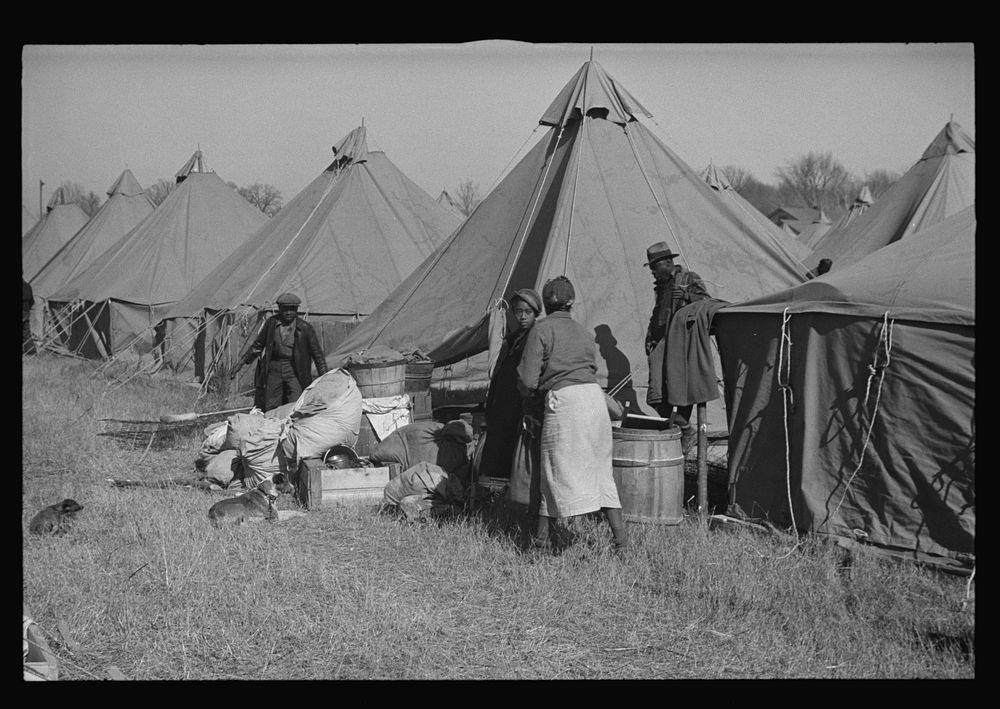 A  flood refugee family who, with their rescued household goods have moved into the camp at Forrest City, Arkansas. Sourced…