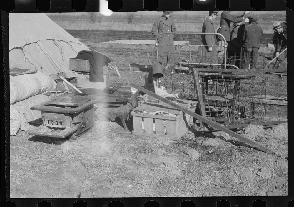 [Untitled photo, possibly related to: A family of flood refugees and their salvaged household goods in the camp at Forrest…