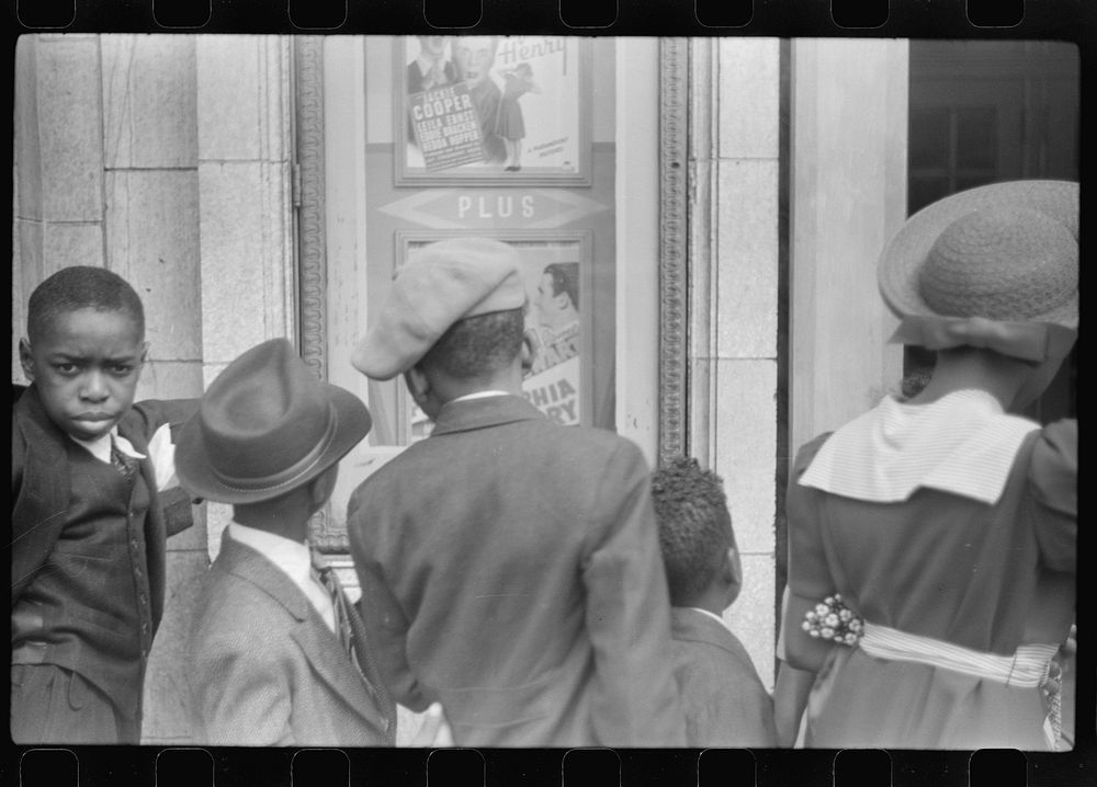 [Untitled photo, possibly related to: Children in front of moving picture theater, Easter Sunday matinee, Black Belt…