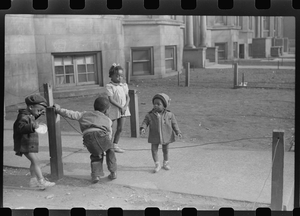 Children in front of apartment buildings in one of the better neighborhoods in the Black Belt, Chicago, Illinois. Sourced…