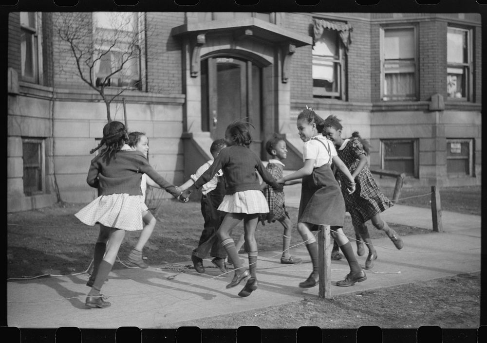 [Untitled photo, possibly related to: Children playing "ring around a rosie" in one of the better neighborhoods of the Black…