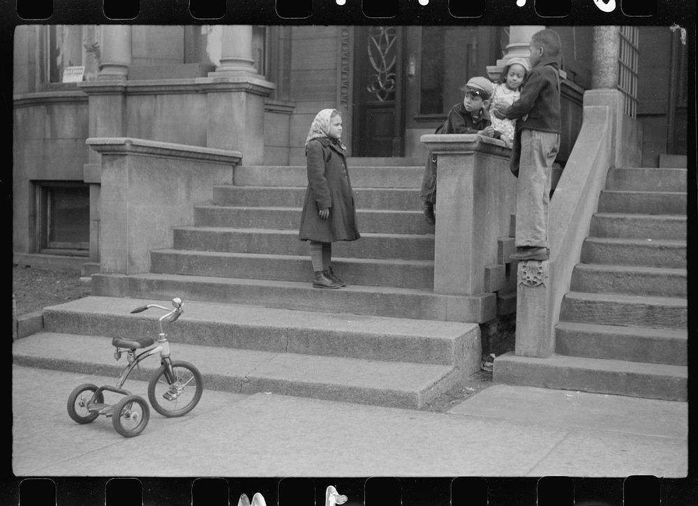[Untitled photo, possibly related to: Children in front of apartment buildings in the better section of the Black Belt…