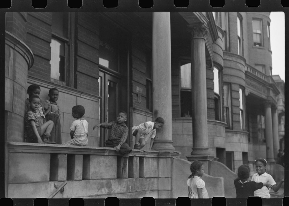 [Untitled photo, possibly related to: Children in front of apartment buildings in the better section of the Black Belt…