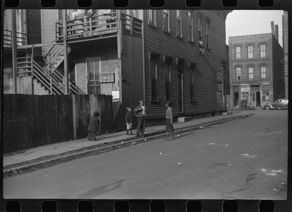 [Untitled photo, possibly related to: es in front of their home, Black Belt, Chicago, Illinois]. Sourced from the Library of…