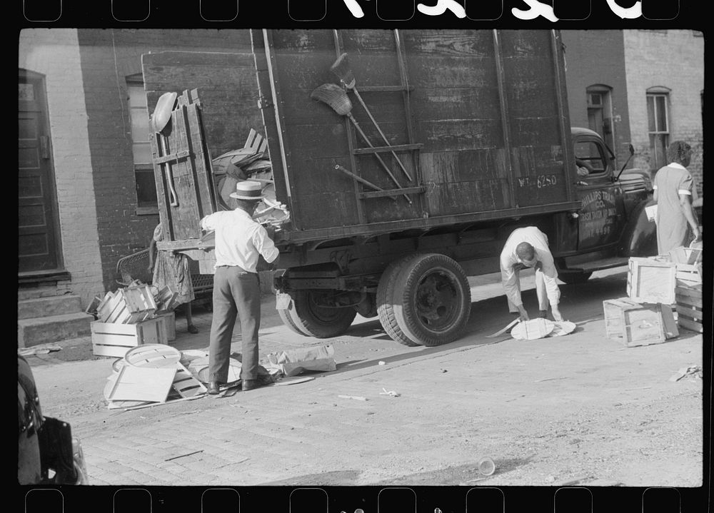 es unloading crates and boxes to be used for firewood, alley dwelling area, Washington, D.C.. Sourced from the Library of…