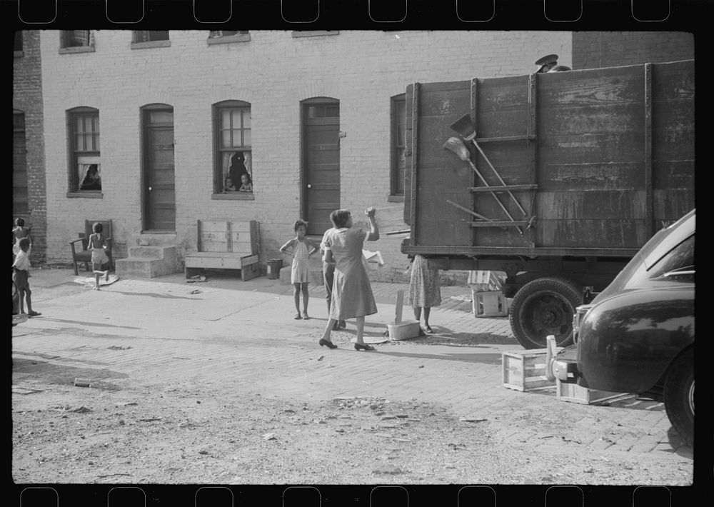 [Untitled photo, possibly related to: es unloading crates and boxes to be used for firewood, alley dwelling area…