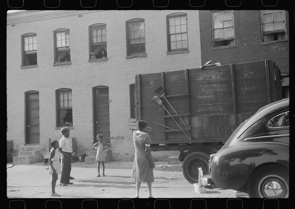 [Untitled photo, possibly related to: es unloading crates and boxes to be used for firewood, alley dwelling area…
