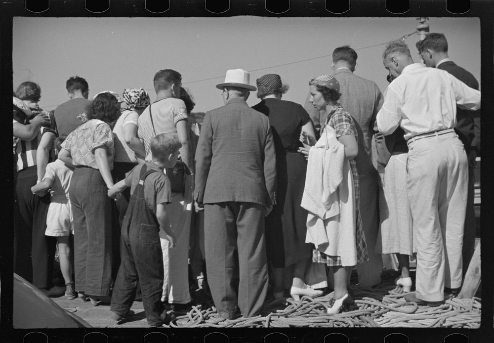 [Untitled photo, possibly related to: Summer residents watch the tourist boat arrive from Boston, Provincetown…