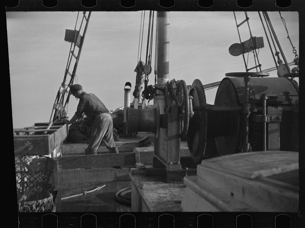[Untitled photo, possibly related to: Aboard a trawler (locally called a dragger). The power-driven winch lets out the…