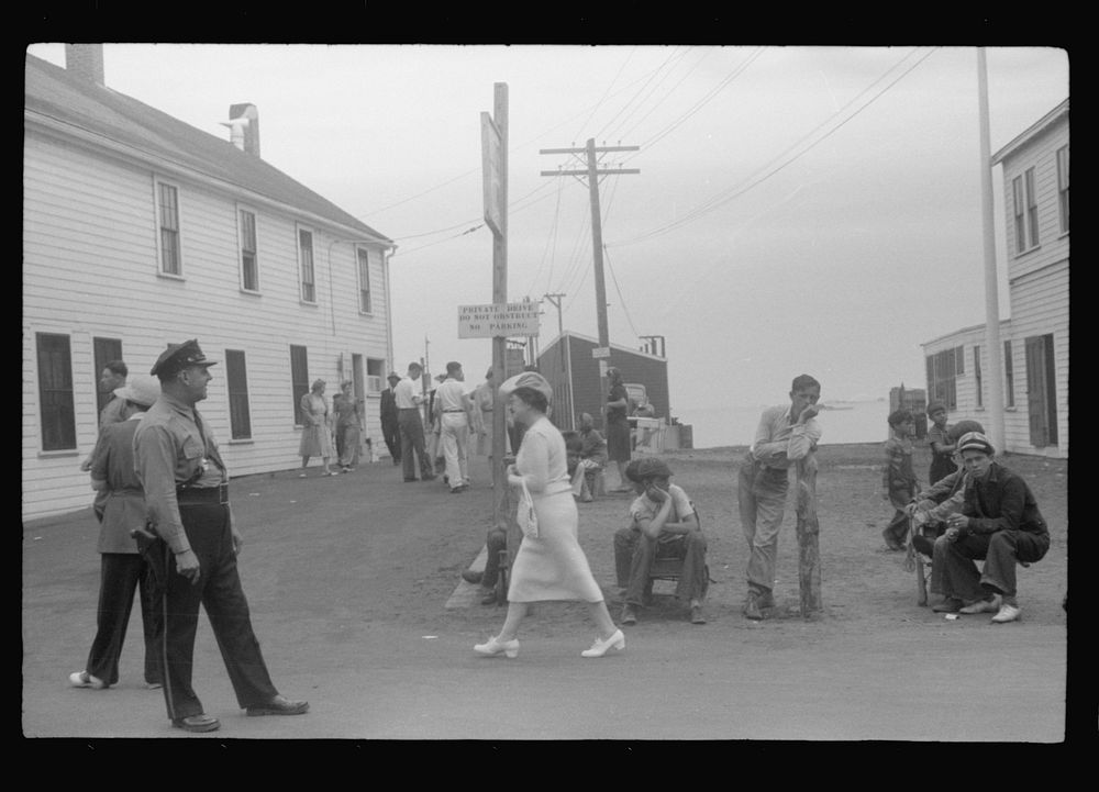 [Untitled photo, possibly related to: Entrance to the town pier before the arrival of the Boston boat. The policeman is an…