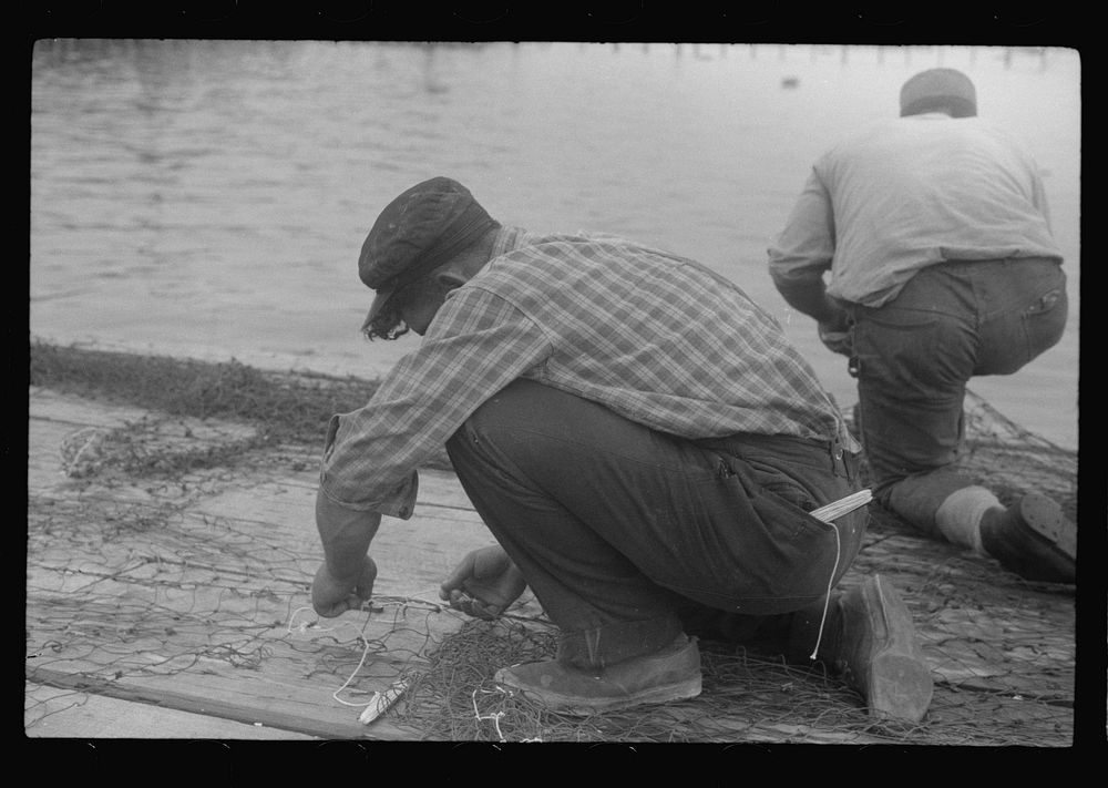 [Untitled photo, possibly related to: Fishermen repairing nets, Provincetown, Massachusetts]. Sourced from the Library of…