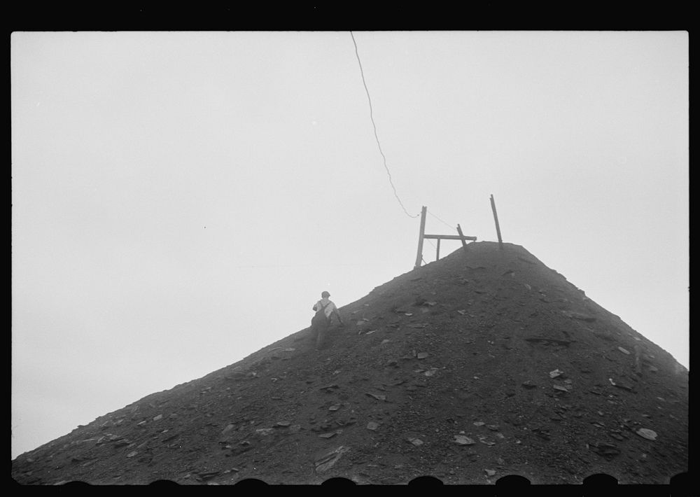 [Untitled photo, possibly related to: Man salvaging coal; they receive ten cents per hundred pound sack or two dollars a…